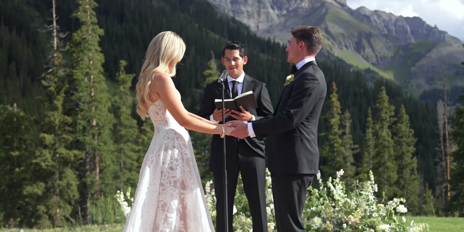 Kaylee and Hunter at an alpine ceremony surrounded by spruce